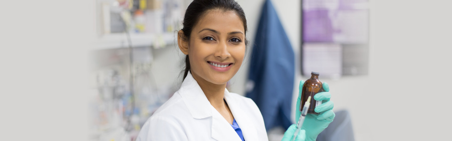 a pharmacist woman holding a syringe needle