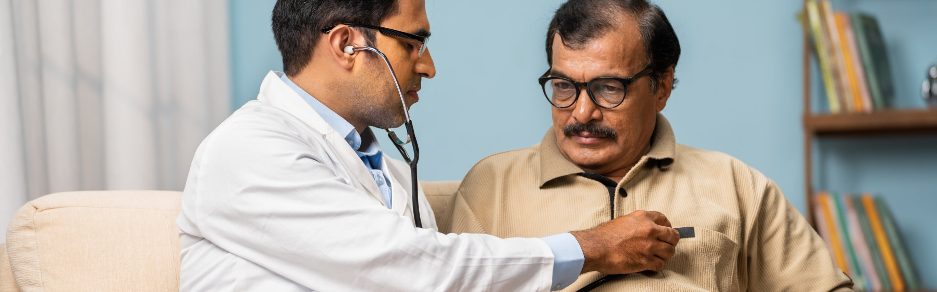 doctor examining senior man by using stethoscope